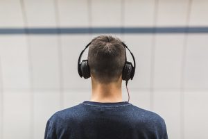 man with headphones facing away