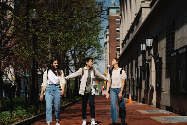 three people walking and talking and smiling
